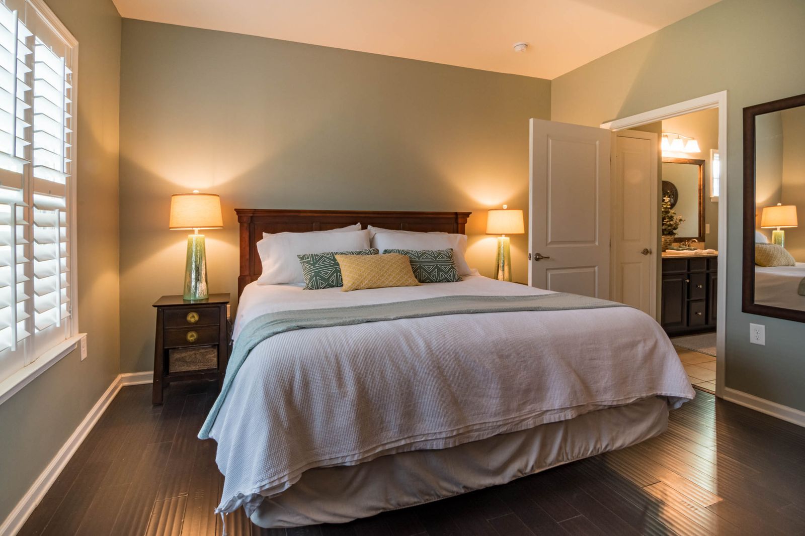 Cozy bedroom in the evening with two glowing bedside lamps